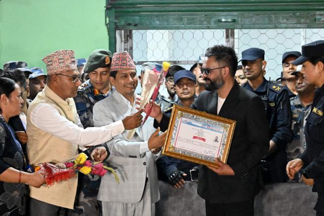 Rastriya Swatantra Party (RSP) election candidate Balendra Shah (centre R) meets supporters after collecting a certificate following his victory in parliamentary elections at the counting centre in Damak in Nepal's Jhapa district on March 7, 2026. Nepal's rapper-turned-mayor Shah grinned and flashed a V for victory sign on March 7 as Election Commission officials confirmed he had defeated veteran leader KP Sharma Oli in their parliamentary constituency. (Photo by Prakash MATHEMA / AFP)