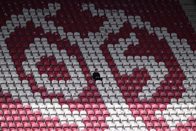 A lone Mainz fan sits in the stands prior to the German first division Bundesliga football match between 1 FSV Mainz 05 and VfB Stuttgart in Mainz, western Germany on March 7, 2026. (Photo by Kirill KUDRYAVTSEV / AFP) / DFL REGULATIONS PROHIBIT ANY USE OF PHOTOGRAPHS AS IMAGE SEQUENCES AND/OR QUASI-VIDEO