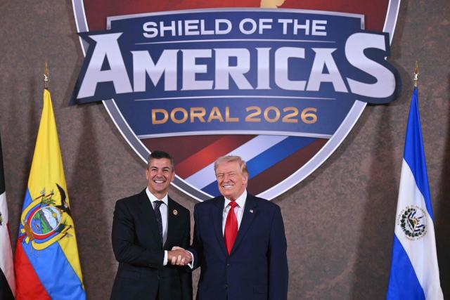 US President Donald Trump shakes hands with Paraguay's President Santiago Pena (L) at the beginning of the "Shield of the Americas" Summit at Trump National Doral in Miami, Florida, March 7, 2026. President Trump is hosting a dozen right-wing leaders from Latin America and the Caribbean to discuss issues facing the region, from organized crime to illegal immigration. The summit also aims to serve Washington by boosting US interests in the region and curbing those from foreign powers like China. (Photo by SAUL LOEB / AFP)