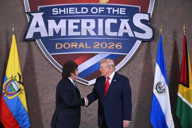 US President Donald Trump shakes hands with Argentina's President Javier Milei (L) at the beginning of the "Shield of the Americas" Summit at Trump National Doral in Miami, Florida, March 7, 2026. President Trump is hosting a dozen right-wing leaders from Latin America and the Caribbean to discuss issues facing the region, from organized crime to illegal immigration. The summit also aims to serve Washington by boosting US interests in the region and curbing those from foreign powers like China. (Photo by SAUL LOEB / AFP)
