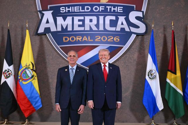 US President Donald Trump and Honduras' President Nasry Asfura (L) pose for a photo at the beginning of the "Shield of the Americas" Summit at Trump National Doral in Miami, Florida, March 7, 2026. President Trump is hosting a dozen right-wing leaders from Latin America and the Caribbean to discuss issues facing the region, from organized crime to illegal immigration. The summit also aims to serve Washington by boosting US interests in the region and curbing those from foreign powers like China. (Photo by SAUL LOEB / AFP)