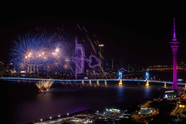 TOPSHOT - A firework and drone display lights up the sky near the Macau Tower shorefront to mark the official end of the traditional Chinese New Year celebrations in Macau on March 7, 2026. (Photo by Eduardo LEAL / AFP)