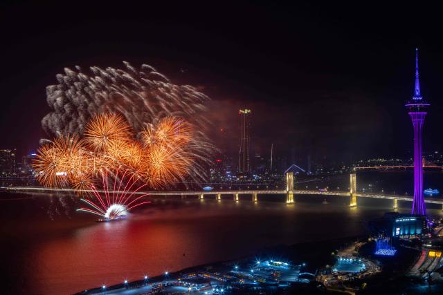 A firework display lights up the sky near the Macau Tower shorefront to mark the official end of the traditional Chinese New Year celebrations in Macau on March 7, 2026. (Photo by Eduardo LEAL / AFP)