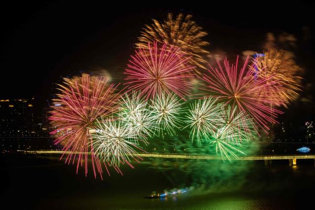 A firework display lights up the sky near the Macau Tower shorefront to mark the official end of the traditional Chinese New Year celebrations in Macau on March 7, 2026. (Photo by Eduardo LEAL / AFP)
