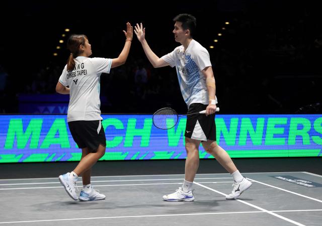 Taiwan’s Ye Hong Wei & Nicole Gonzales celebrate their win against China's Tang Chun Man & Tse Ying Suet during the mixed doubles semi-final at the All England Open Badminton Championships at the Utilita Arena in Birmingham, central England, on March 7, 2026. (Photo by Darren Staples / AFP)