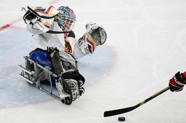 Germany's goalkeeper Simon Kunst makes a save during the ice hockey match between China and Germany at the Milano Cortina 2026 Paralympic Winter Games in Milan on March 7, 2026. (Photo by Stefano RELLANDINI / AFP)