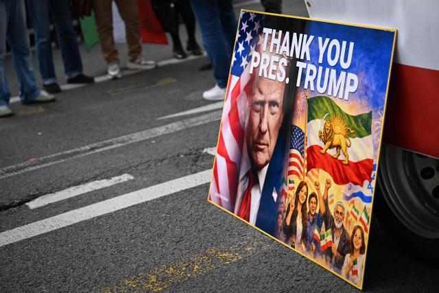 This photograph shows a placard reading "Thank you President Trump" displayed as supporters of Iran's last crown prince, now key opposition figure, Reza Pahlavi gather to take part in a march for Iran in Paris on March 7, 2026, amid the ongoing war in the Middle East. (Photo by Lou BENOIST / AFP)