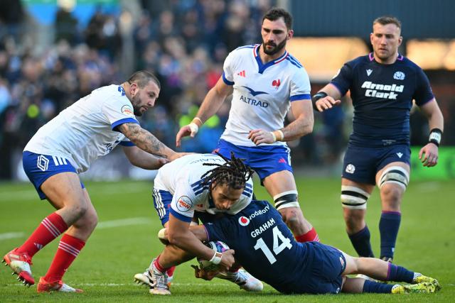 France's lock Mickael Guillard is tackled by Scotland's wing Darcy Graham during the Six Nations international rugby union match between Scotland and France at Murrayfield Stadium in Edinburgh, Scotland on March 7, 2026. (Photo by ANDY BUCHANAN / AFP)