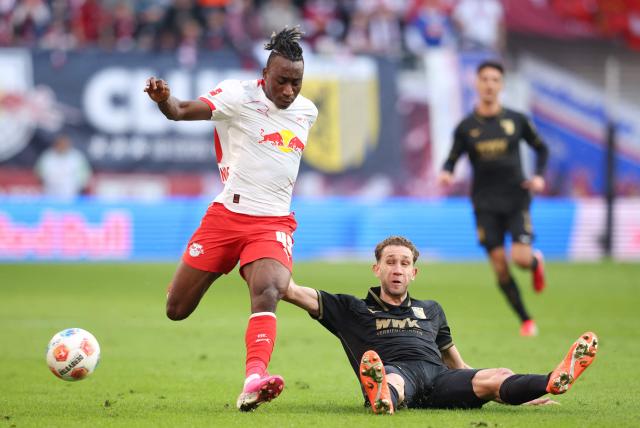 Leipzig's Ivorian forward #49 Yan Diomande (L) and Augsburg's Brazilian defender #34 Arthur Chaves vie for the ball during the Bundesliga football match between RB Leipzig and Augsburg in Leipzig, eastern Germany, on March 7, 2026. (Photo by Ronny HARTMANN / AFP) / DFL REGULATIONS PROHIBIT ANY USE OF PHOTOGRAPHS AS IMAGE SEQUENCES AND/OR QUASI-VIDEO