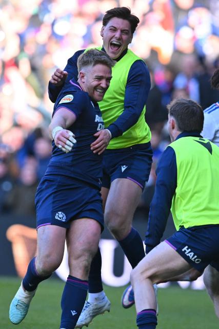 Scotland's wing Kyle Steyn (L) celebrates with the reserves after scoring their fifth try during the Six Nations international rugby union match between Scotland and France at Murrayfield Stadium in Edinburgh, Scotland on March 7, 2026. (Photo by ANDY BUCHANAN / AFP)