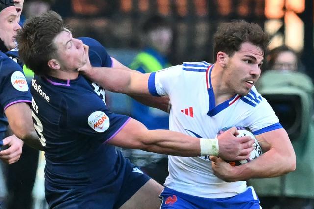 France's scrum-half Antoine Dupont hands-off Scotland's centre Huw Jones during the Six Nations international rugby union match between Scotland and France at Murrayfield Stadium in Edinburgh, Scotland on March 7, 2026. (Photo by ANDY BUCHANAN / AFP)