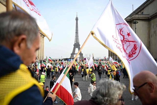 Supporters of the People's Mojahedin Organization of Iran political group gather at the Place du Trocadero near the Eiffel Tower as they take part in a rally "Neither Shah, nor Mullah" to protest against Islamic Republic of Iran government in Paris on March 7, 2026, amid the ongoing war in the Middle East. (Photo by LOU BENOIST / AFP)