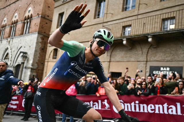 Decathlon CMA CGM Team's French Paul Seixas waves after crossing the finish line to win second place in the 20th one-day classic 'Strade Bianche' (White Roads) men's cycling race between Siena and Siena in Tuscany on March 7, 2026. (Photo by Marco BERTORELLO / AFP)
