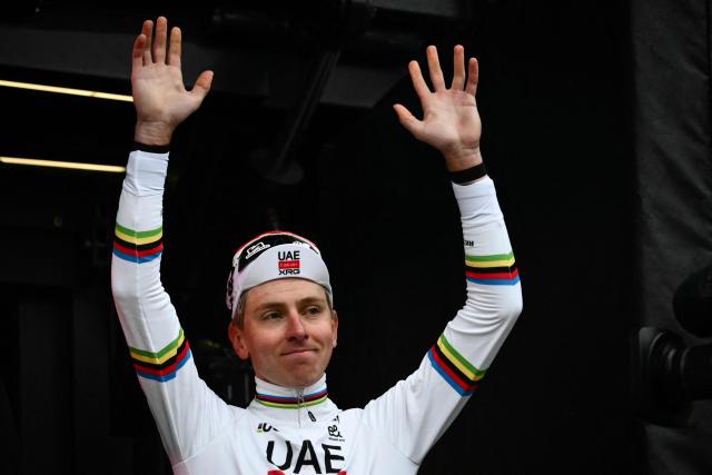 UAE Team Emirates's Slovenian Tadej Pogacar waves as he celebrates on the podium after winning the 20th one-day classic 'Strade Bianche' (White Roads) men's cycling race between Siena and Siena in Tuscany on March 7, 2026. (Photo by Marco BERTORELLO / AFP)