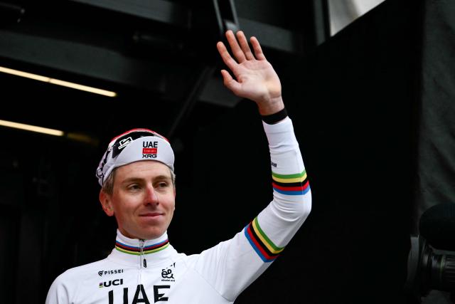UAE Team Emirates's Slovenian Tadej Pogacar waves as he celebrates on the podium after winning the 20th one-day classic 'Strade Bianche' (White Roads) men's cycling race between Siena and Siena in Tuscany on March 7, 2026. (Photo by Marco BERTORELLO / AFP)