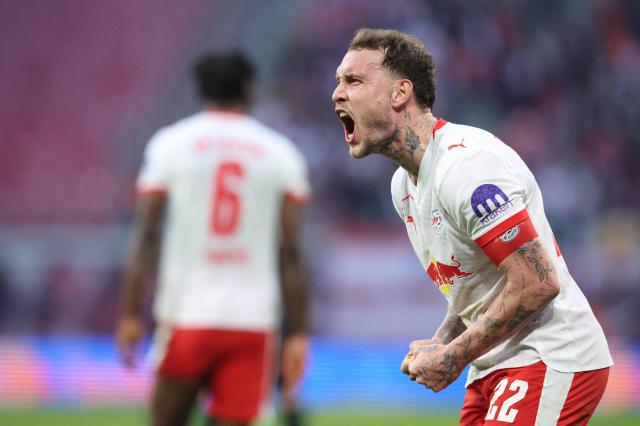 Leipzig's German defender #22 David Raum celebrates after an own goal of Augsburg to mark 2-1 during the Bundesliga football match between RB Leipzig and Augsburg in Leipzig, eastern Germany, on March 7, 2026. (Photo by Ronny HARTMANN / AFP) / DFL REGULATIONS PROHIBIT ANY USE OF PHOTOGRAPHS AS IMAGE SEQUENCES AND/OR QUASI-VIDEO