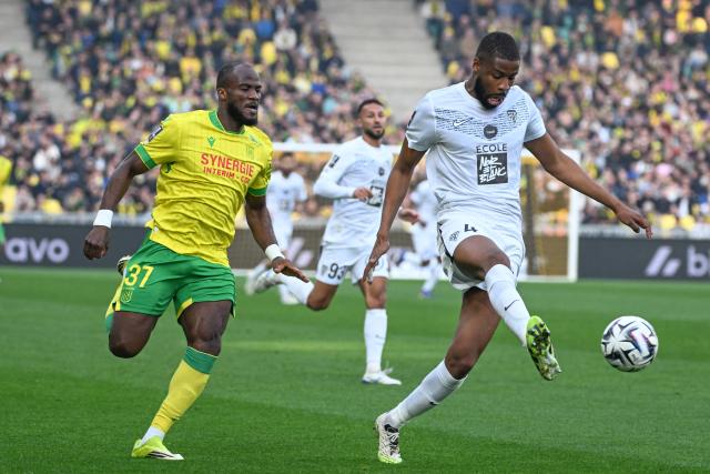 Nantes' Cameroonian forward #37 Ignatius Ganago (L) fights for the ball with Angers' Malian defender #4 Ousmane Camara (R) during the French L1 football match between FC Nantes and SCO Angers at the Stade de la Beaujoire–Louis Fonteneau in Nantes, western France on March 7, 2026. (Photo by Sebastien Salom-Gomis / AFP)