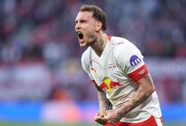 Leipzig's German defender #22 David Raum celebrates after an own goal of Augsburg to mark 2-1 during the Bundesliga football match between RB Leipzig and Augsburg in Leipzig, eastern Germany, on March 7, 2026. (Photo by Ronny HARTMANN / AFP) / DFL REGULATIONS PROHIBIT ANY USE OF PHOTOGRAPHS AS IMAGE SEQUENCES AND/OR QUASI-VIDEO