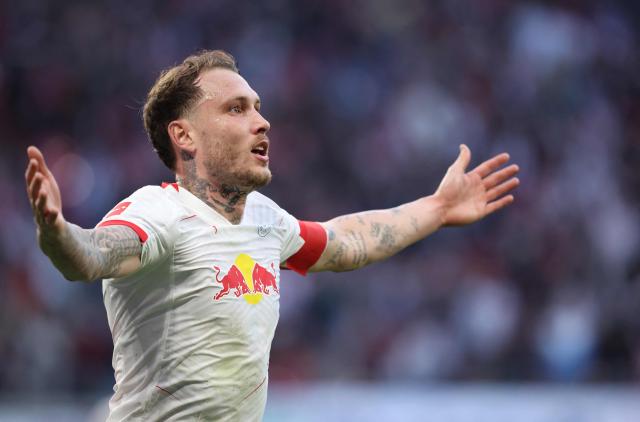 Leipzig's German defender #22 David Raum celebrates after an own goal of Augsburg to mark 2-1 during the Bundesliga football match between RB Leipzig and Augsburg in Leipzig, eastern Germany, on March 7, 2026. (Photo by Ronny HARTMANN / AFP) / DFL REGULATIONS PROHIBIT ANY USE OF PHOTOGRAPHS AS IMAGE SEQUENCES AND/OR QUASI-VIDEO