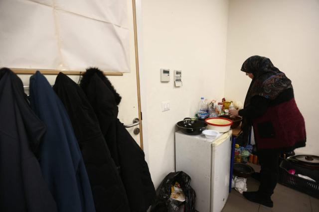 A displaced woman who lives with her family in a school's classroom after fleeing Israeli airstrikes in Beirut's southern suburbs, prepares their "iftar" fast-breaking meal in Beirut on March 7, 2026. Lebanon's social affairs minister said on March 7, that 454,000 people had been registered as displaced since the outbreak of the new war between Israel and Hezbollah. In a press briefing, Haneen Sayed said that the total number of people who registered their names on a website affiliated with the ministry reached 454,000, including 112,525 people registered in government shelters. (Photo by Ibrahim AMRO / AFP)