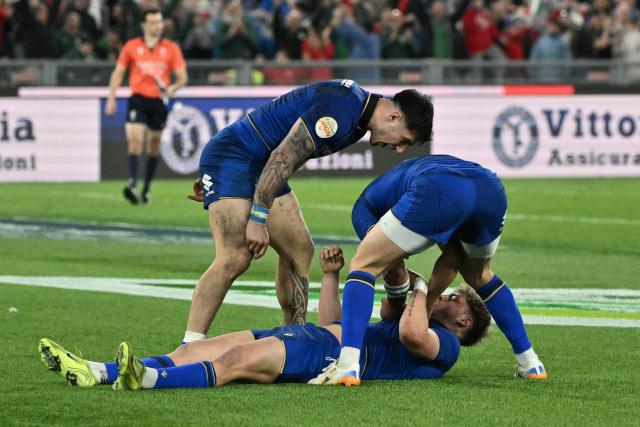 Italy's centre Leonardo Marin (bottom) celebrates after scoring a try during the Six Nations international rugby union match between Italy and England at the Stadio Olimpico in Rome, on March 7, 2026. (Photo by Tiziana FABI / AFP)