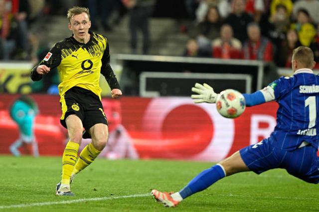 Dortmund's German forward #14 Maximilian Beier (L) scores the 0-2 goal past FC Cologne's German goalkeeper #01 Marvin Schwaebe during the German first division Bundesliga football match 1 FC Cologne v BVB Borussia Dortmund in Cologne, western Germany, on March 7, 2026. (Photo by INA FASSBENDER / AFP) / DFL REGULATIONS PROHIBIT ANY USE OF PHOTOGRAPHS AS IMAGE SEQUENCES AND/OR QUASI-VIDEO