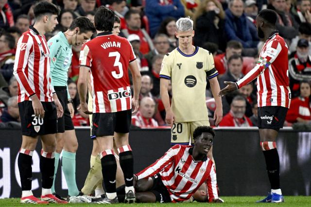 Barcelona's Spanish defender #24 Eric Garcia and Athletic Bilbao's Spanish defender #19 Adama Boiro lay on the ground after falling during the Spanish league football match between Athletic Club Bilbao and FC Barcelona at San Mames Stadium in Bilbao on March 7, 2026. (Photo by ANDER GILLENEA / AFP)