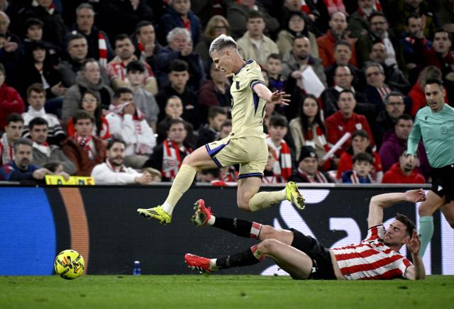 Barcelona's Spanish midfielder #20 Daniel Olmo fights for the ball with Athletic Bilbao's French forward #14 Aymeric Laporte during the Spanish league football match between Athletic Club Bilbao and FC Barcelona at San Mames Stadium in Bilbao on March 7, 2026. (Photo by ANDER GILLENEA / AFP)
