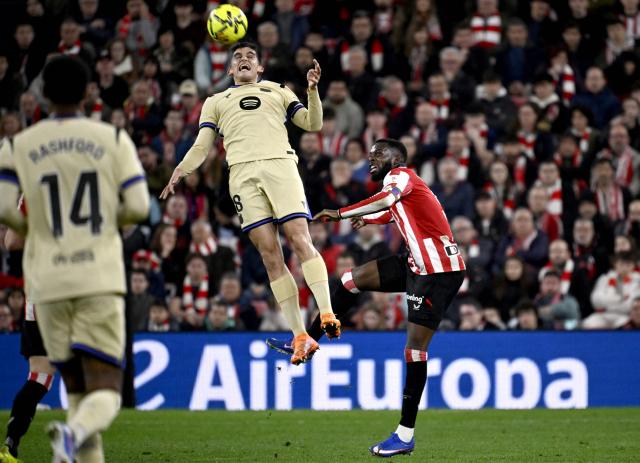 Barcelona's Spanish defender #18 Gerard Martin heads the ball next to Athletic Bilbao's Ghanaian forward #09 Inaki Williams during the Spanish league football match between Athletic Club Bilbao and FC Barcelona at San Mames Stadium in Bilbao on March 7, 2026. (Photo by ANDER GILLENEA / AFP)