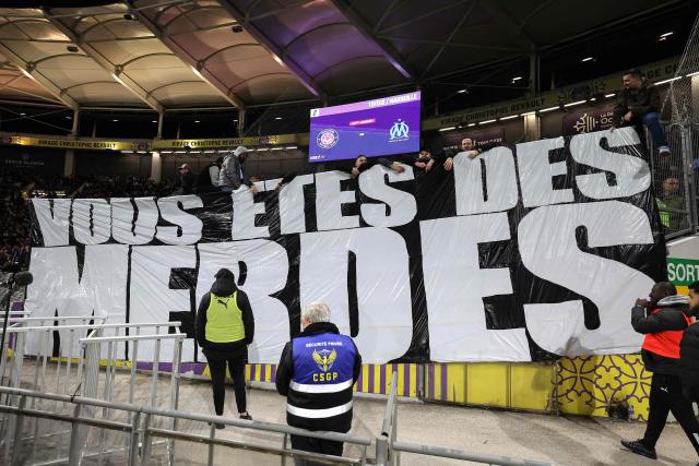 Marseille's supporters hold a banner reading "You are shits" during the French L1 football match between Toulouse FC and Olympique de Marseille (OM) at the TFC Stadium in Toulouse, southwestern France, on March 7, 2026. (Photo by Valentine CHAPUIS / AFP)