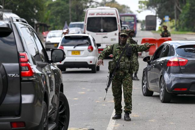A Colombian soldier stops a car at a roadside checkpoint on the Pan-American Highway in Tunia, Cauca department, Colombia, on the eve of the legislative elections, on March 7, 2026. Colombia will hold legislative elections on March 8 and presidential elections on May 31. (Photo by Joaquín SARMIENTO / AFP)