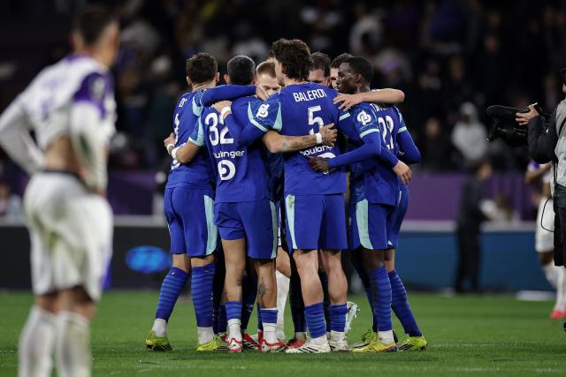 Marseille's players celebrate their victory at the end of the French L1 football match between Toulouse FC and Olympique de Marseille (OM) at the TFC Stadium in Toulouse, southwestern France, on March 7, 2026. (Photo by Valentine CHAPUIS / AFP)