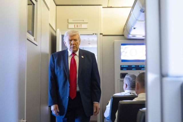 US President Donald Trump walks to speak with the media aboard Air Force One during a flight from Dover, Delaware, to Miami, Florida, on March 7, 2026. (Photo by SAUL LOEB / AFP)