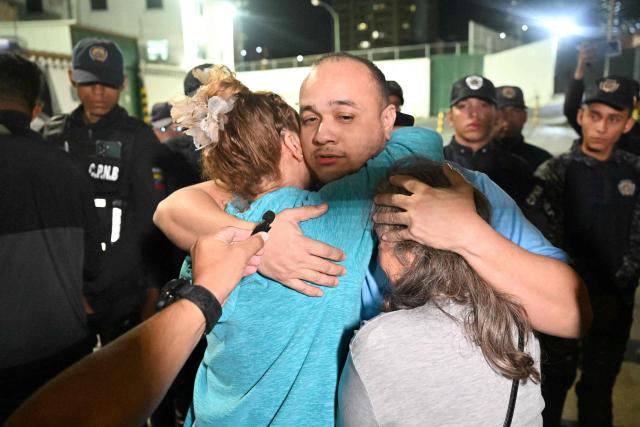 A Venezuelan prisoner hugs his relatives after being released from the Bolivarian National Police (PNB) Zone 7 prison in Caracas on March 7, 2026. (Photo by Juan BARRETO / AFP)