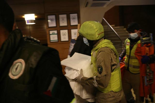 First aid responders gather at a Ramada hotel that was targeted by an Israeli strike, in Beirut’s seaside Rawche area, on March 8, 2026. (Photo by IBRAHIM AMRO / AFP)