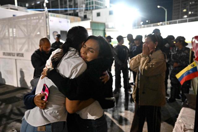 Relatives of Venezuelan prisoners embrace during their release from the Bolivarian National Police (PNB) Zone 7 prison in Caracas on March 7, 2026. (Photo by Juan BARRETO / AFP)