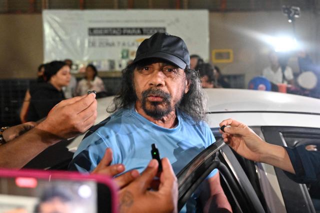 Venezuelan deputy Fernando Orozco gestures after being released from the Bolivarian National Police (PNB) Zone 7 prison in Caracas on March 7, 2026. (Photo by Juan BARRETO / AFP)