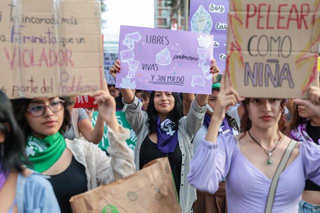 Demonstrators show signs during a march on the eve of International Women's Day in Lima on March 7, 2026. (Photo by Connie FRANCE / AFP)