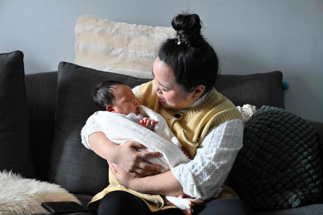 Zhang Xiaofei looks at her baby Zhu Wanning in Langfang, northern China's Hebei province on March 6, 2026. The world's second-most populous country is threatened with a demographic crisis after its birth rate halved over the past decade -- all while people rapidly age out of the workforce. (Photo by Adek BERRY / AFP) / TO GO WITH AFP STORY: China-economy-demographics-infants, by Mary YANG
