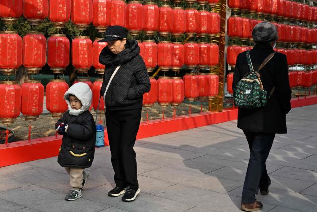 People visit a park in Beijing on March 7, 2026. The world's second-most populous country is threatened with a demographic crisis after its birth rate halved over the past decade -- all while people rapidly age out of the workforce. (Photo by Adek BERRY / AFP) / TO GO WITH AFP STORY: China-economy-demographics-infants, by Mary YANG