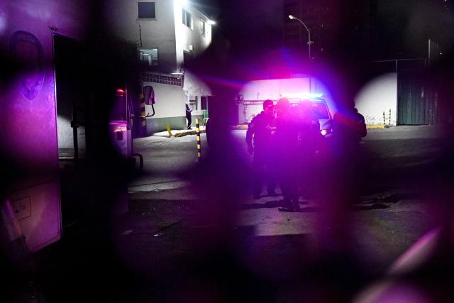 Venezuelan police officers stand guard during the release of prisoners at the entrance to the Bolivarian National Police (PNB) Zone 7 prison in Caracas on March 7, 2026. (Photo by Juan BARRETO / AFP)