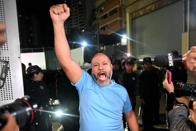Venezuelan prisoner Gilberto Alcala raises his fist after being released from the Bolivarian National Police (PNB) Zone 7 prison in Caracas on March 7, 2026. (Photo by Juan BARRETO / AFP)