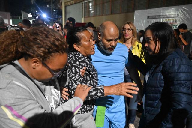 Venezuelan prisoner Gilberto Alcala gathers with relatives after being released from the Bolivarian National Police (PNB) Zone 7 prison in Caracas on March 7, 2026. (Photo by Juan BARRETO / AFP)