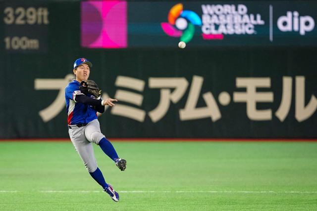 Taiwan’s Chiang Kun-yu throws the ball to first base during the World Baseball Classic (WBC) Pool C game between Taiwan and South Korea at the Tokyo Dome in Tokyo on March 8, 2026. (Photo by Yuichi YAMAZAKI / AFP)