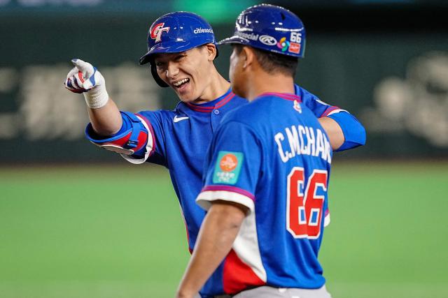 Taiwan’s Chen Chen-wei reacts after hitting a single during the World Baseball Classic (WBC) Pool C game between Taiwan and South Korea at the Tokyo Dome in Tokyo on March 8, 2026. (Photo by Yuichi YAMAZAKI / AFP)