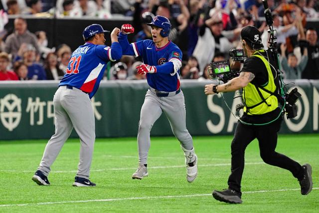 Taiwan’s Stuart Fairchild (C) celebrates as he hits a two run home run during the World Baseball Classic (WBC) Pool C game between Taiwan and South Korea at the Tokyo Dome in Tokyo on March 8, 2026. (Photo by Yuichi YAMAZAKI / AFP)