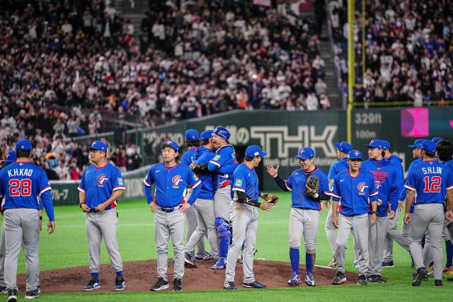 Taiwan players celebrate their victory after the World Baseball Classic (WBC) Pool C game between Taiwan and South Korea at the Tokyo Dome in Tokyo on March 8, 2026. (Photo by Yuichi YAMAZAKI / AFP)