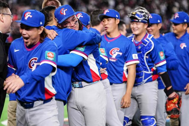 Taiwan players celebrate their victory after the World Baseball Classic (WBC) Pool C game between Taiwan and South Korea at the Tokyo Dome in Tokyo on March 8, 2026. (Photo by Yuichi YAMAZAKI / AFP)