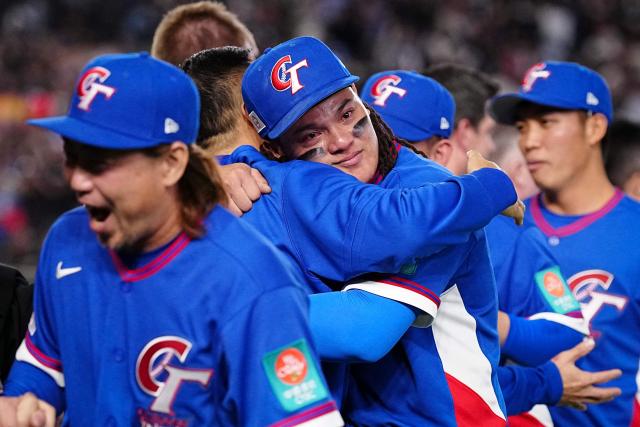 Taiwan’s Yu Chang (C) celebrates team's victory after the World Baseball Classic (WBC) Pool C game between Taiwan and South Korea at the Tokyo Dome in Tokyo on March 8, 2026. (Photo by Yuichi YAMAZAKI / AFP)