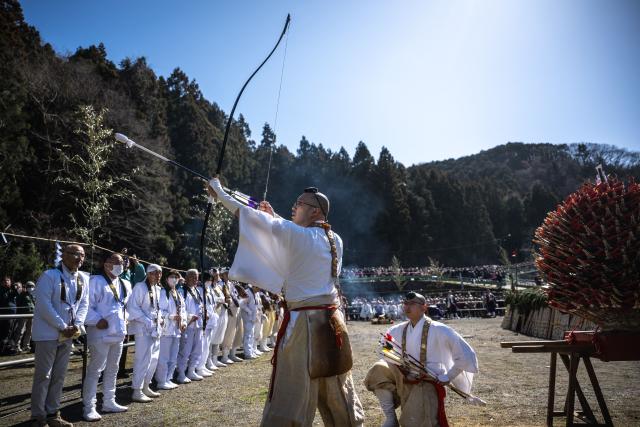 A buddhist monk takes part in an archery ceremony before the annual "Hiwatari Matsuri", known as fire walking festival, at the Takaosan Yakuoin Temple in Hachioji area, the western portion of the Tokyo Metropolis on March 8, 2026. (Photo by Philip FONG / AFP)